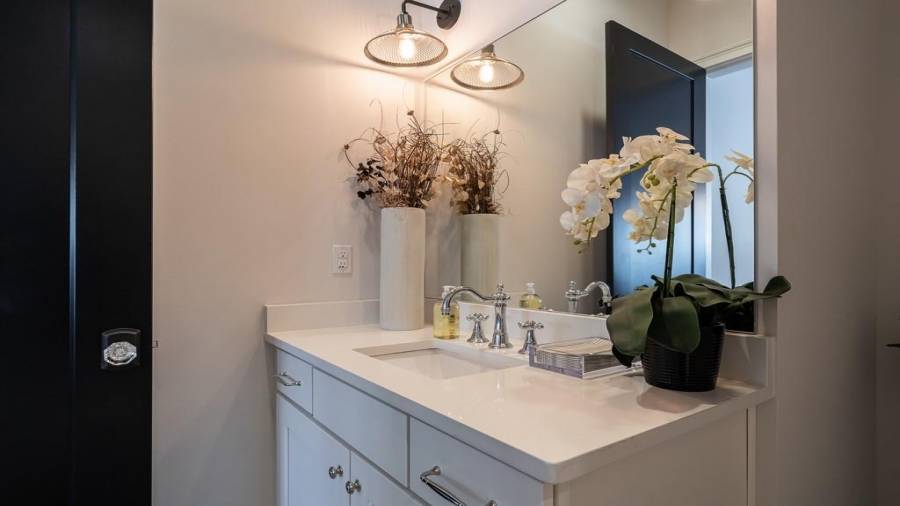 Guest bathroom with Quartz counters and marble floor is located on the terrace level.