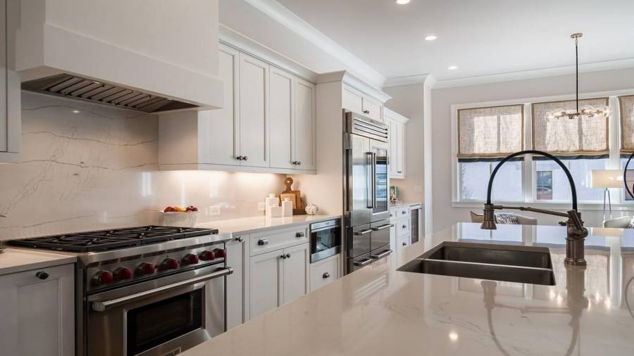 Wolf gas range and vent hood, Subzero drawer microwave, Subzero built-in glass door refrigerator and wine cooler and Asko dishwasher.