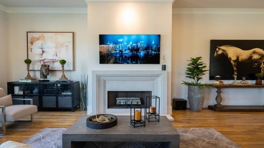 The living room is anchored with this Gorgeous Limestone fireplace surround.