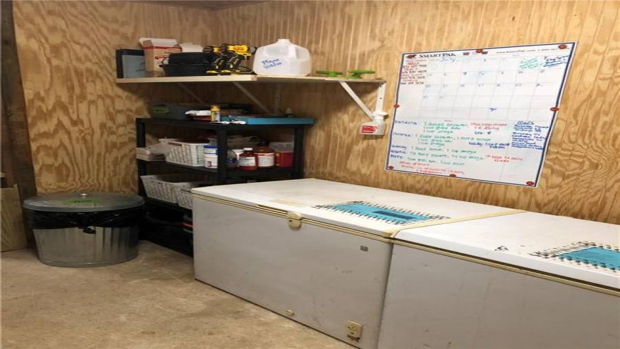 8x12 climate controlled feed room. Feed is stored in old deep freezers to keep it fresher and prevent bugs and critters from getting to it. Freezers will be left if desired. The larger of the 2 holds 5 50lb bags and the smaller holds 3 50lb bags.