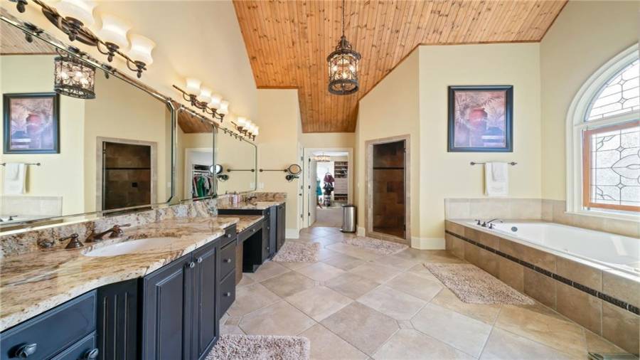 Beamed Vaulted Ceilings, Beautiful Tile, Double Jetted Tub and Sauna Shower!