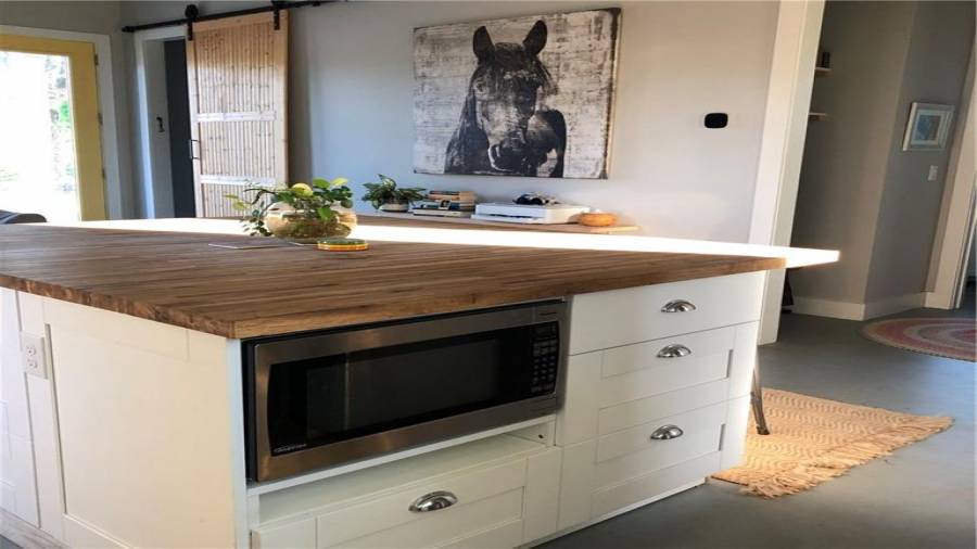 large island with storage space on 3 sides and built in microwave