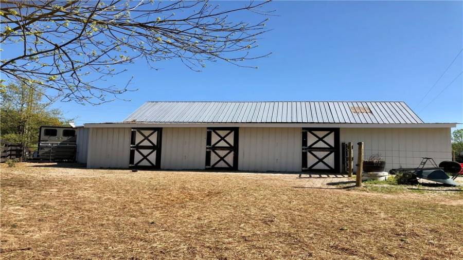 Back of the barn with 3 stalls that have access to the mare-foal/drylot paddock. there are 2 sections of paddock separated by a gate for easy control of space for a newborn or rehabbing horse.