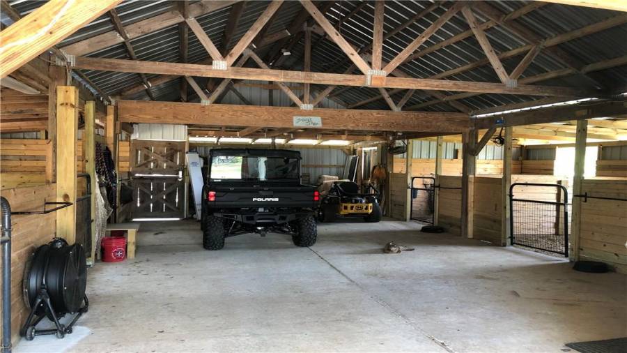 Aisle is large enough to store equipment if necessary and still move horses in and out of stalls.