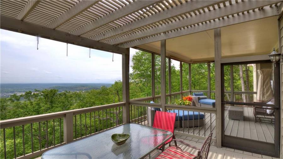 Outdoor porch with pergola, and a perfect area for outside dining to enjoy the view.