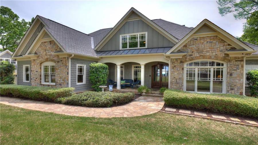 Flagstone walkway and front porch with a rock paver walkway around the home.