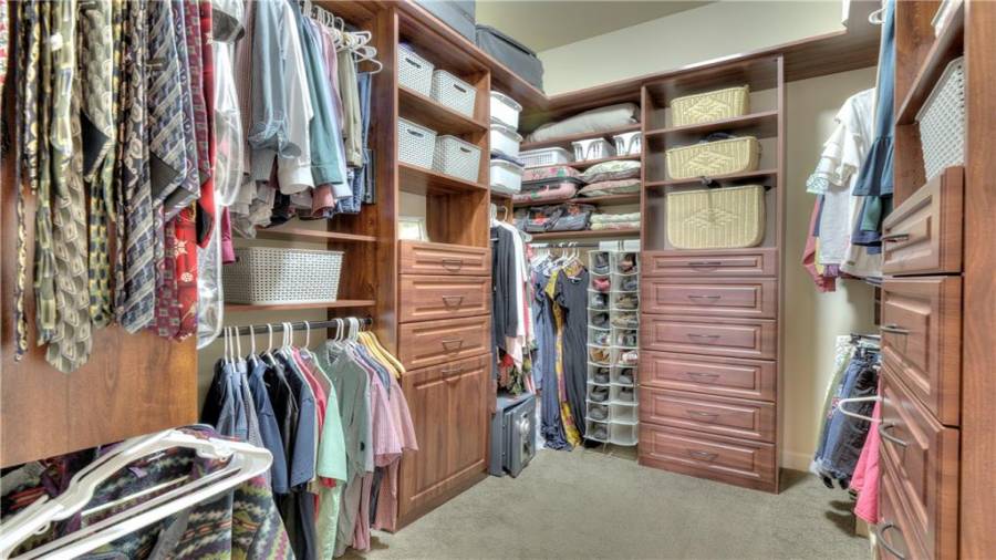 Large custom walk-in closet with plenty of cabinetry for all your clothing storage!