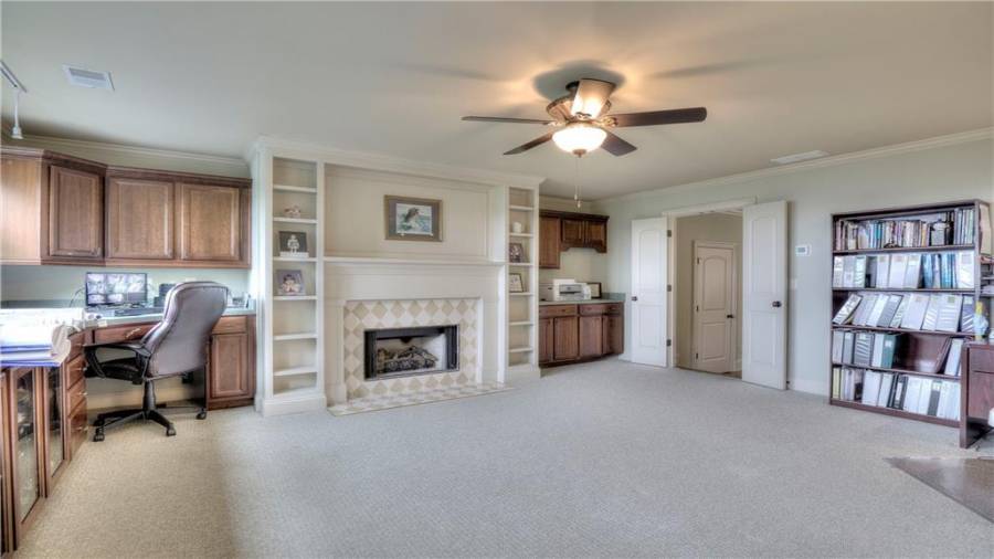 Huge Office with custom tiled fireplace, built-in book shelves and a plethora of wood cabinetry and work surfaces!
