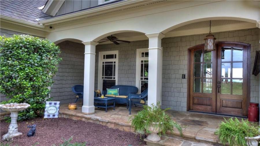 Rocking chair front porch and gorgeous custom glass/wood doors provide for a beautiful entry!
