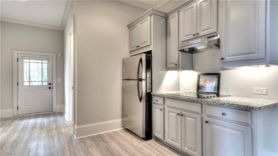 Terrace Level Kitchen with full size refrigerator and electric cooktop with vent hood.