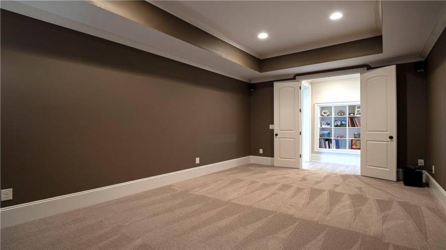 Double doors to hallway to built in shelves, another closet and mechanical room with more storage space.
