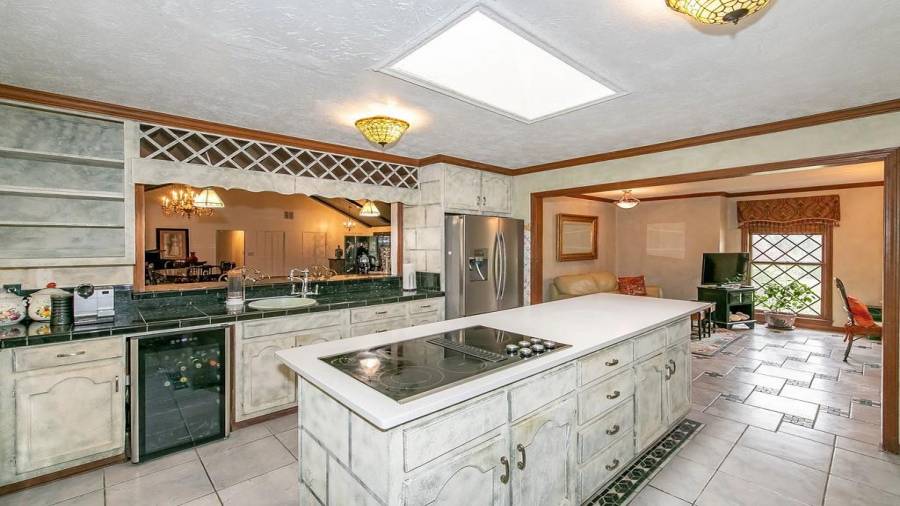 Kitchen with island, granite tile counter, wine cooler and tons of cabinet storage