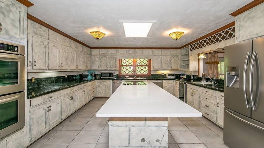 Kitchen with island, granite tile counter, wine cooler and tons of cabinet storage