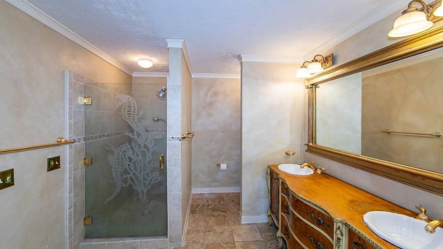 Owner private bath with double vanity, tile walk in shower and whirlpool sauna tub