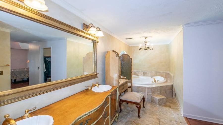 Owner private bath with double vanity, tile walk in shower and whirlpool sauna tub