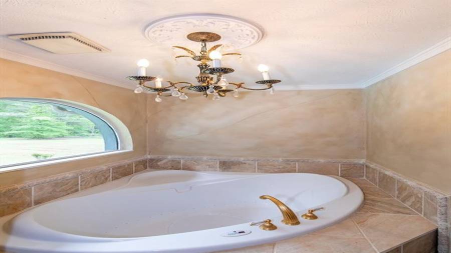 Owner private bath with double vanity, tile walk in shower and whirlpool sauna tub