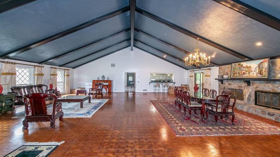 Ballroom like living room and dining room with fireplace