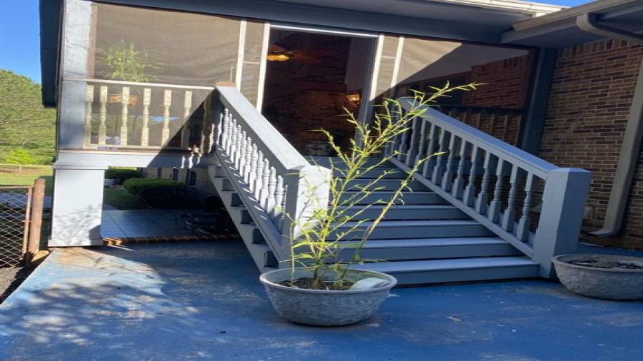 Steps from covered deck to backyard