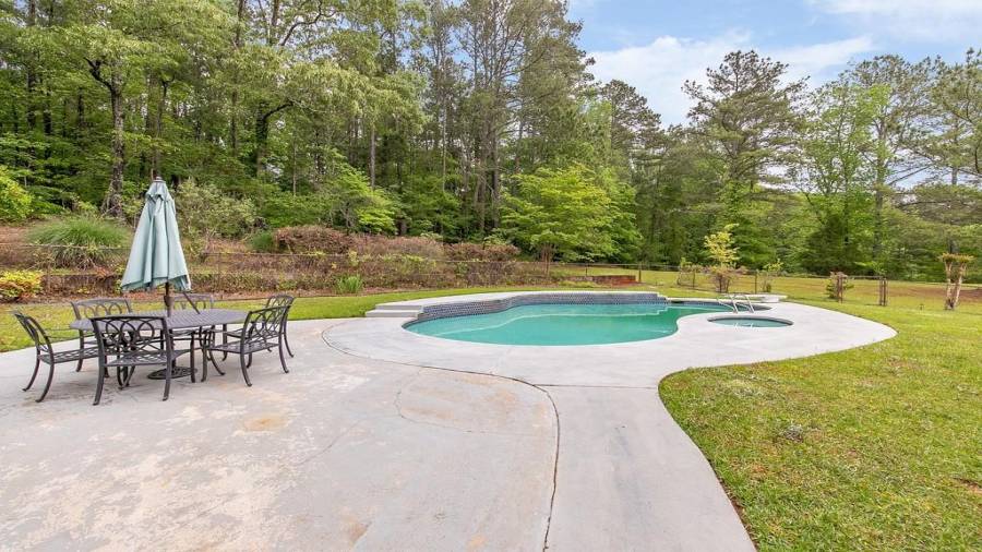 Fenced pool/spa area with paved space to spread out your towel on