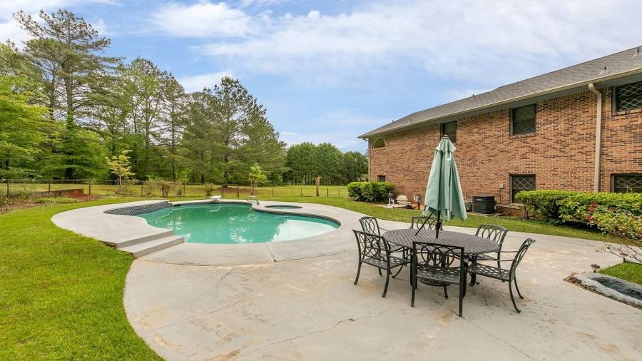 Fenced pool/spa area with paved space to spread out your towel on