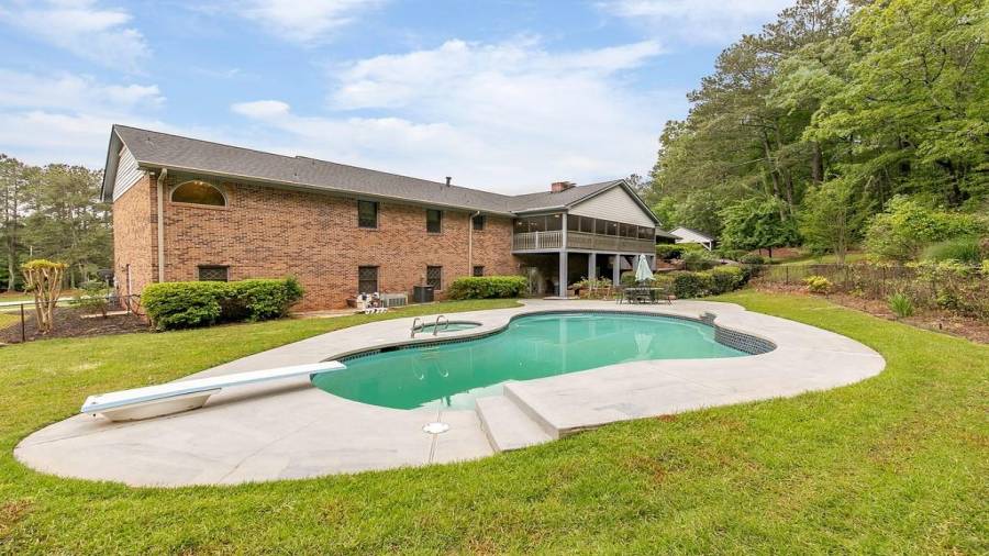Fenced pool/spa area with paved space to spread out your towel on