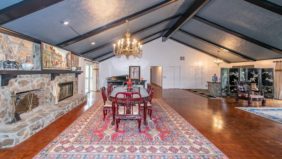 Ballroom like living room and dining room with fireplace