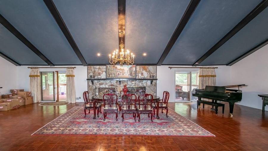 Ballroom like living room and dining room with fireplace