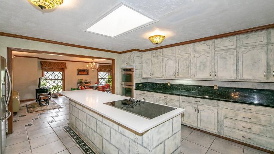 Kitchen with island, granite tile counter, wine cooler and tons of cabinet storage