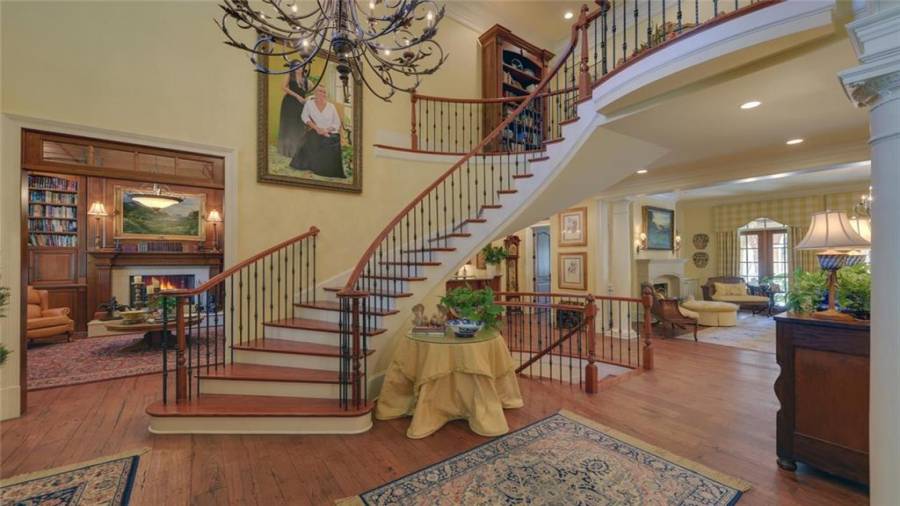 The curved staircase adds to the beauty of the two story entry foyer.