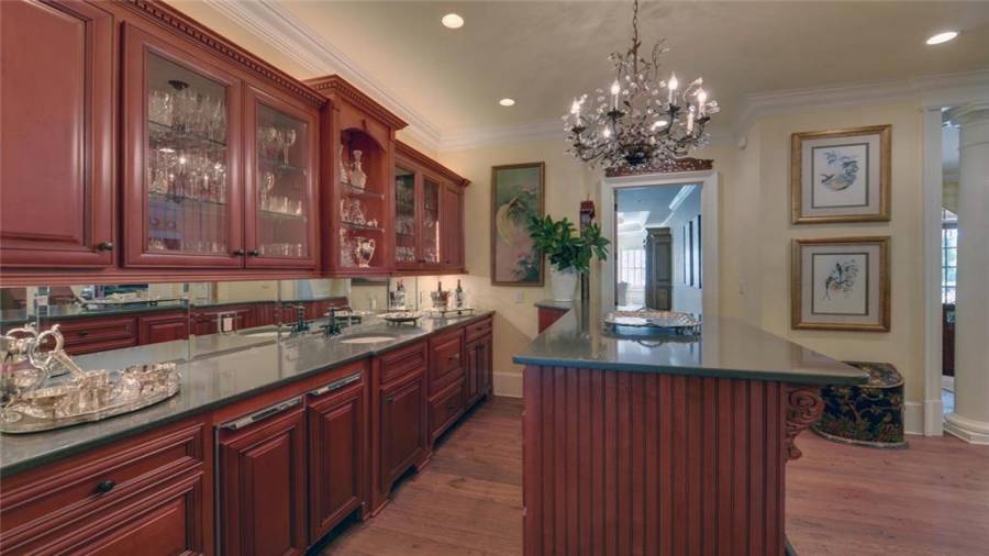 Additional view of custom bar with wet sink which is great when entertaining or hosting family functions.