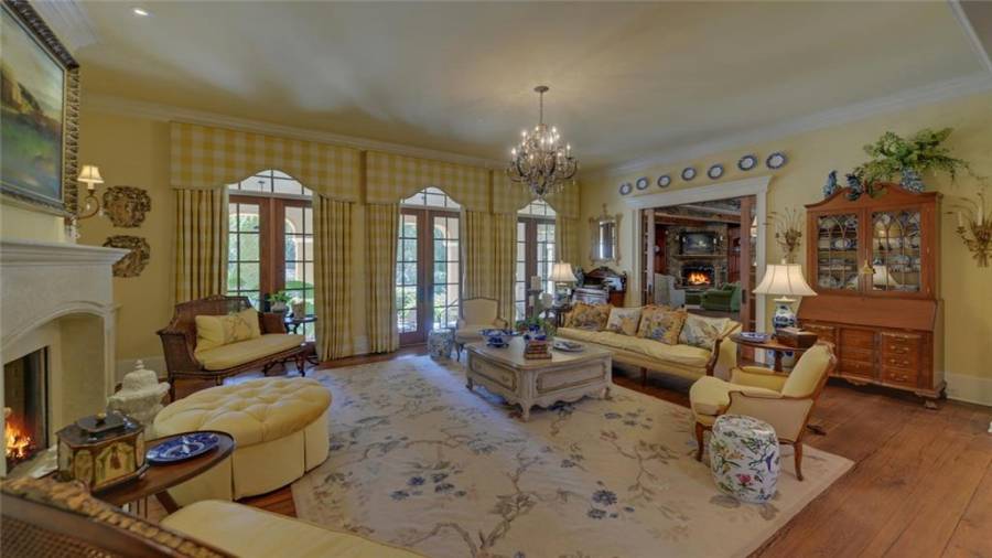 Living room features include a fireplace, custom built-ins and access to the covered veranda and walk way.