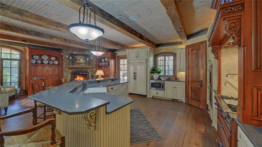 The gourmet kitchen features a large center island, double ovens and gas cook top with pot filler.