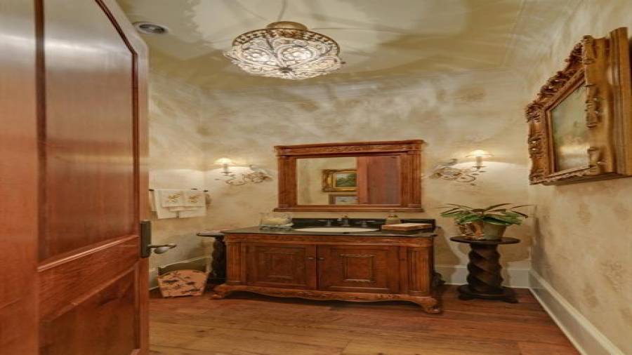 Half bath off hallway with custom vanity.