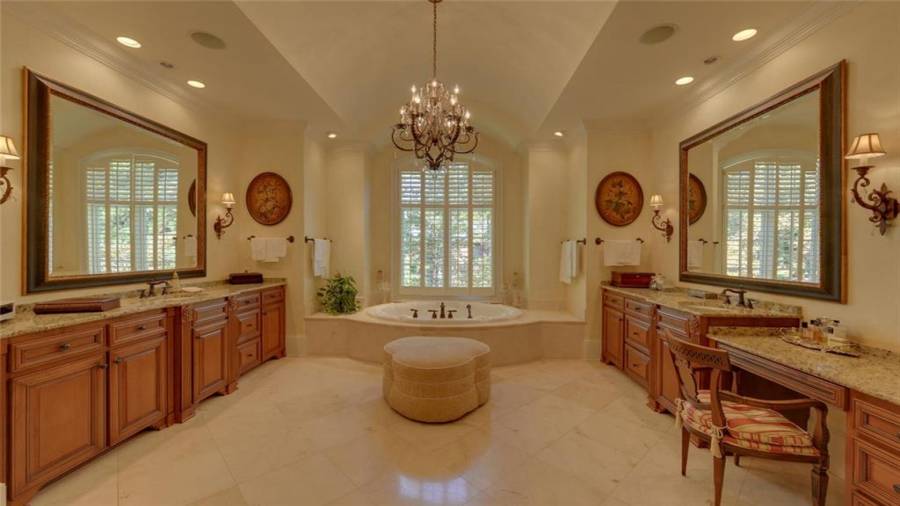 Master bath with beautiful cabinetry featuring Rocky Mountain hardware, vanity area and Jacuzzi tub.