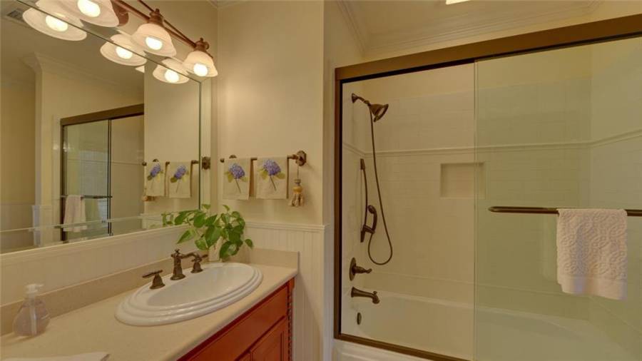 Full bath with a tub/shower combo.