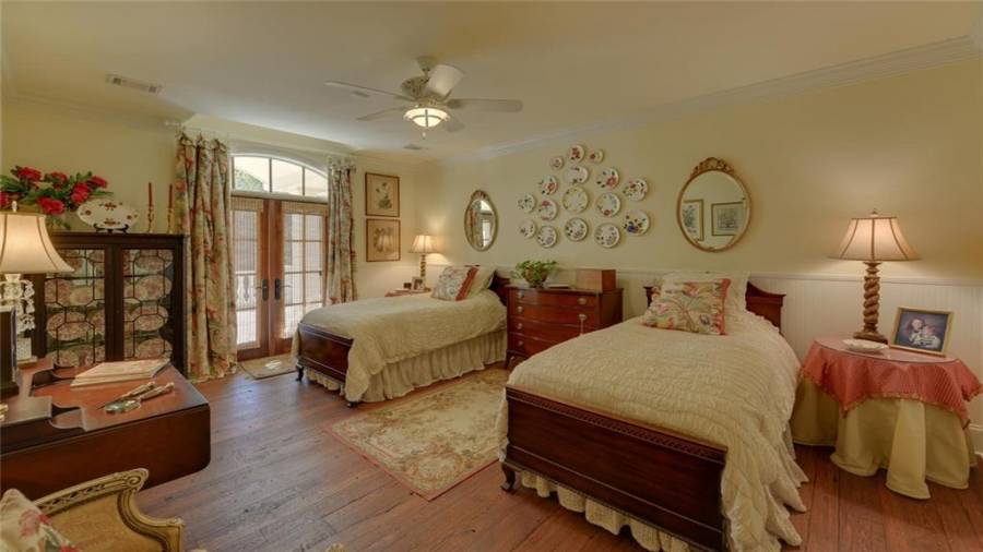 Second of the bedroom suites on the upper level.  The double doors lead out to a covered veranda overlooking the gardens and pool.