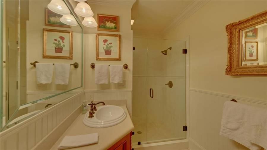 Full bath with walk-in tiled shower.