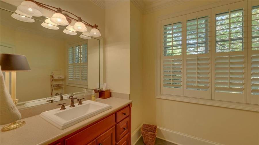 Guest suite full bath with two separate vanity areas.