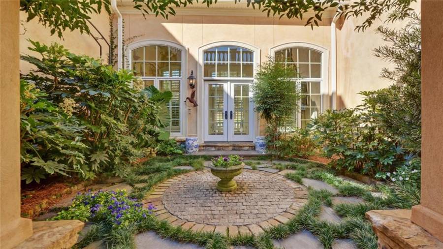 Enjoy this beautiful view of a courtyard garden while dining alfresco.