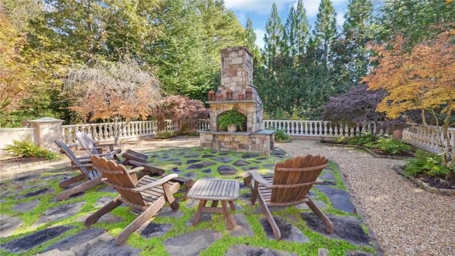 Additional view of the fireplace and gardens.