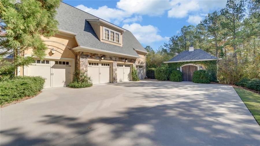 Side entry 3 car garage plus a golf cart garage with a large parking pad.  Garden shed for all your garden accessories.