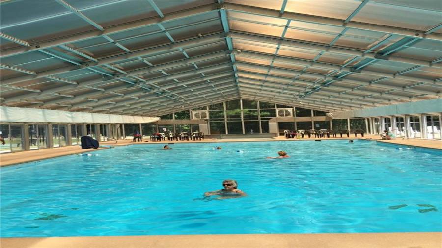 Huge indoor heated pool that has locker rooms and showers! Ceiling will stay open in the summer and closed in the winter.