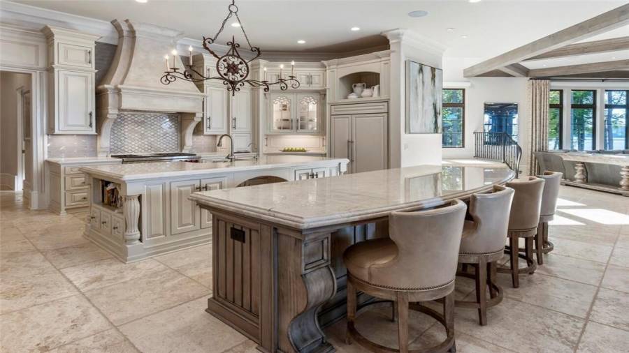 Double islands with quartzite countertops. Custom concrete cast vent hood.