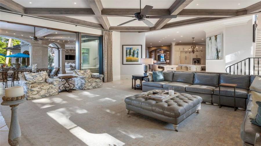 Family room with massive doors that completely open to covered loggia and is open to kitchen.