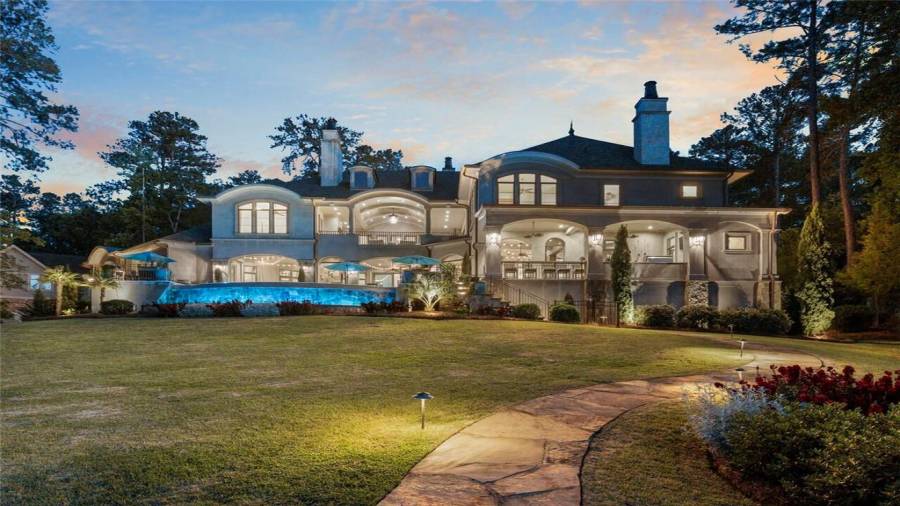 Gardens, a private beach, infinity pool, and boat and jet ski dock on almost an acre and 210 feet of water frontage.