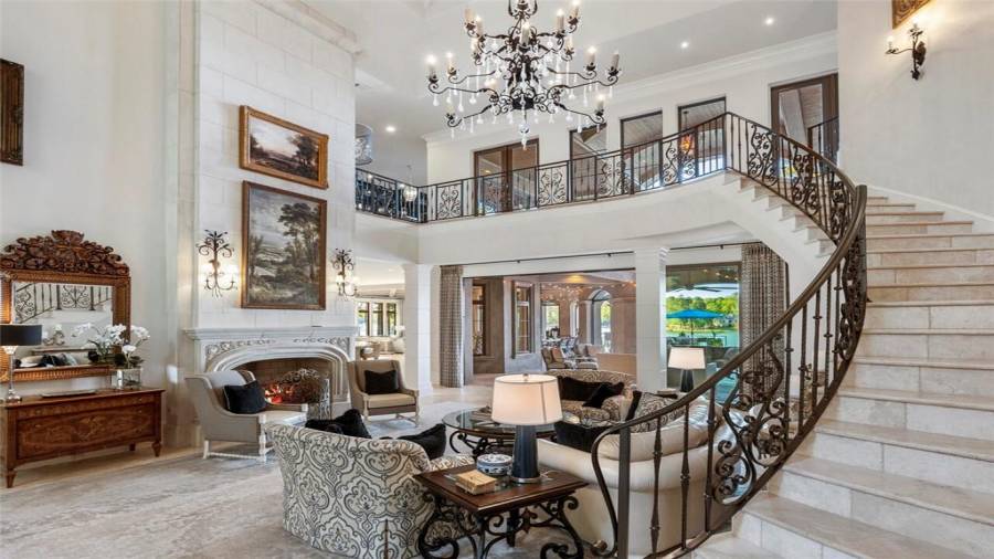 Italian travertine flooring and stairs, custom ironwork staircase.