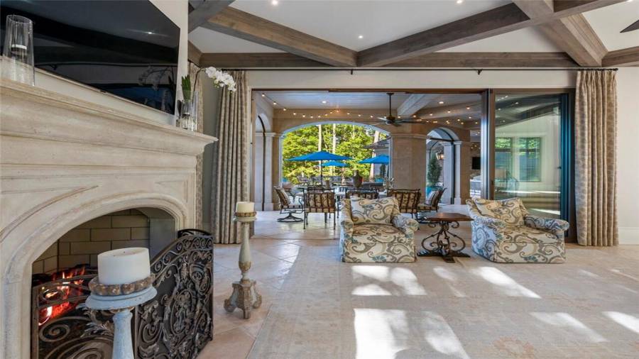 Sliding doors open from the family room to covered outdoor dining.