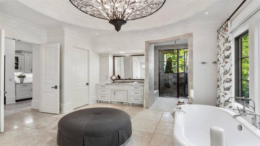 Owners Suite bath with motorized blinds and heated floors.