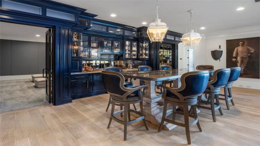 Stunning blue bar upstairs overlooks the lake and opens to the home theatre.