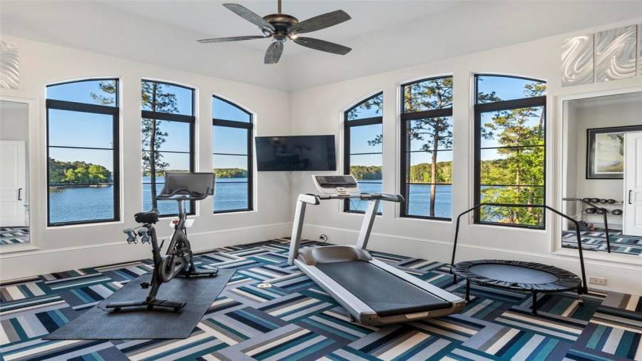 Home gym with lake views upstairs with second floor views of the lake.